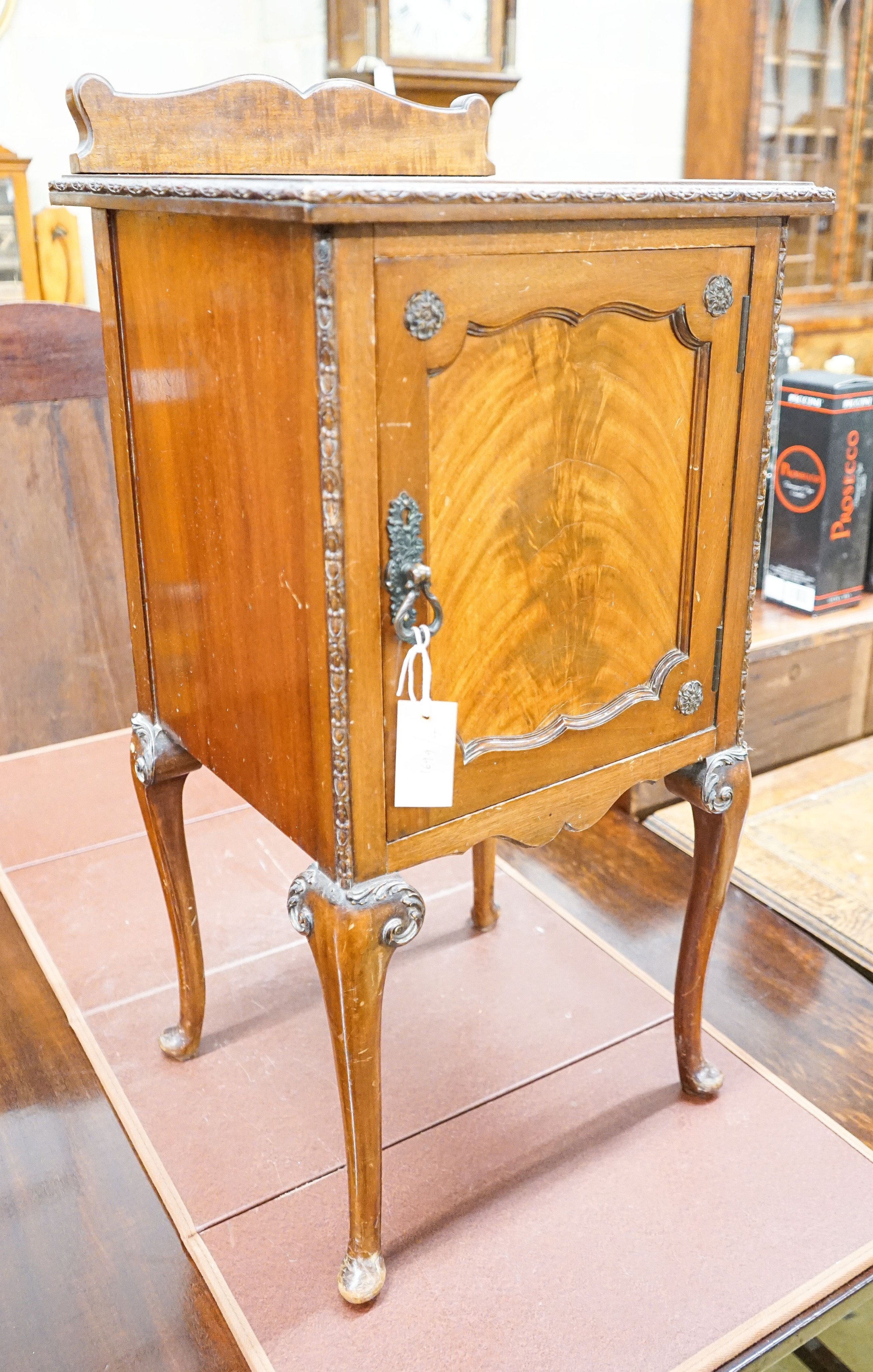 A Queen Anne style carved and figured mahogany bedside cabinet, width 40cm, depth 38cm, height 84cm